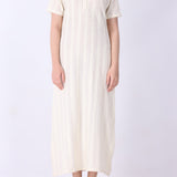 Cream pointelle dress with gold jewellery styling