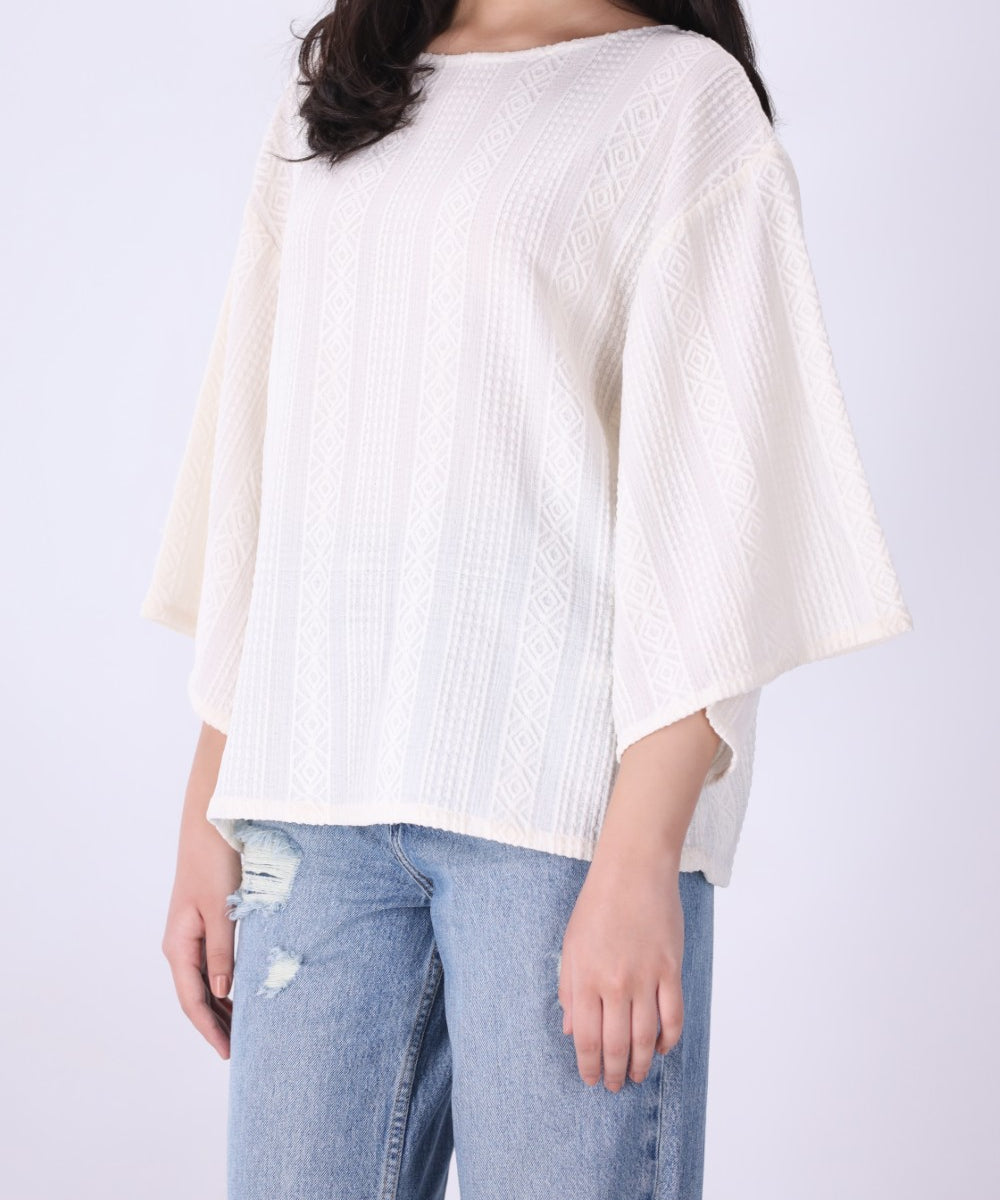 Back view of cream batwing top

