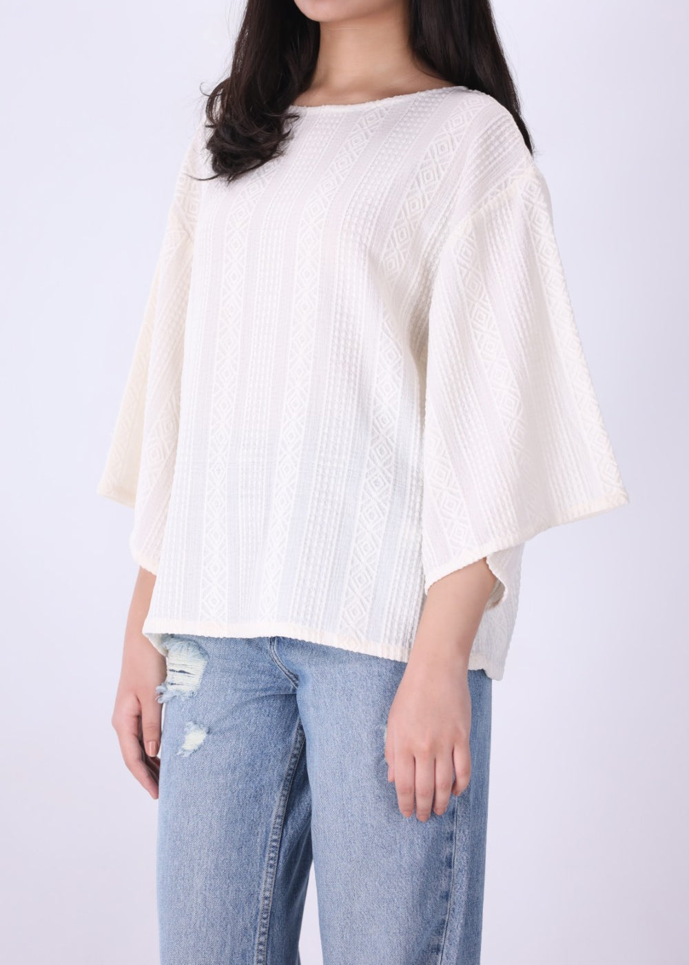Back view of cream batwing top
