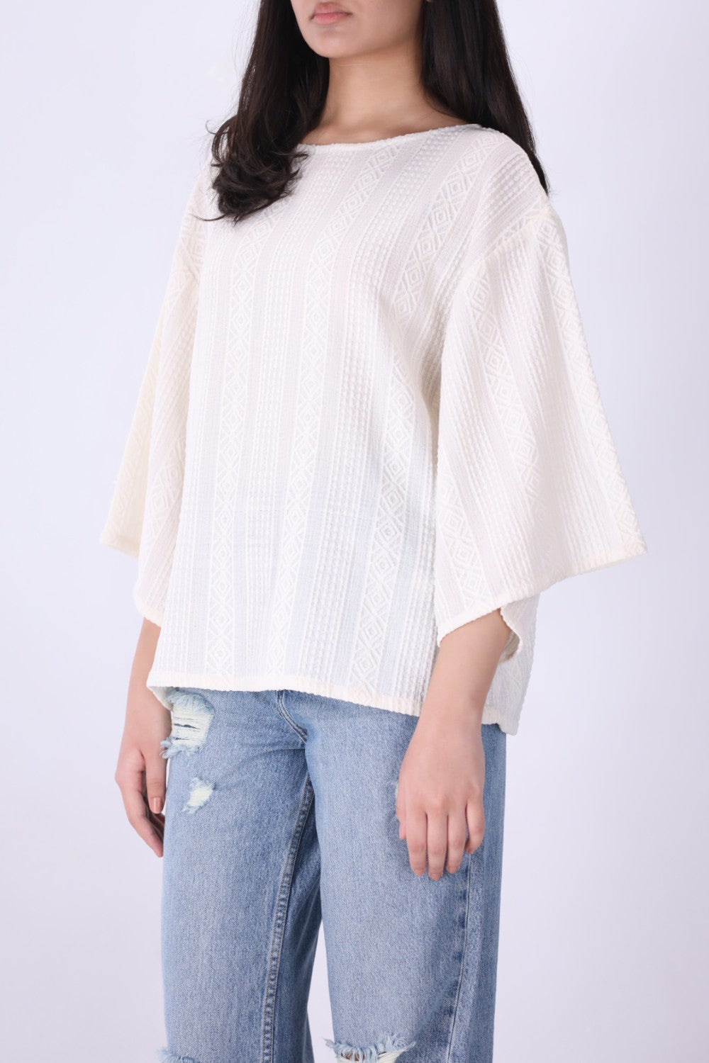 Back view of cream batwing top
