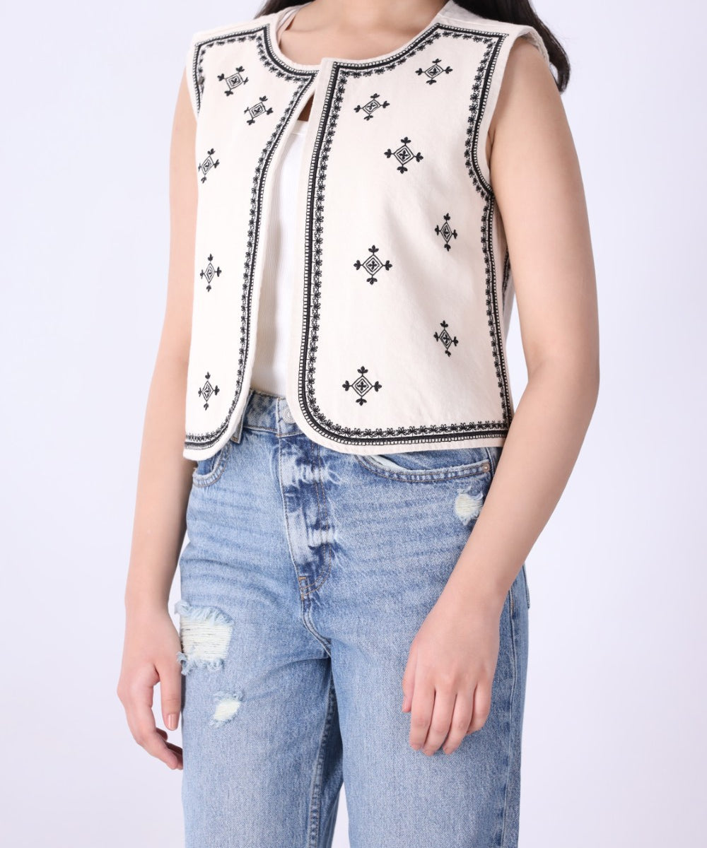 Back view of embroidered ivory vest
