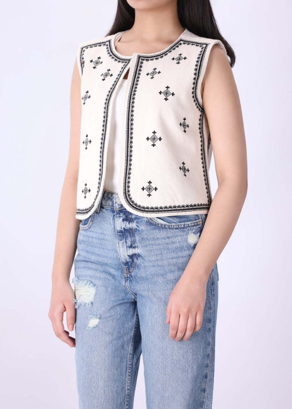 Back view of embroidered ivory vest
