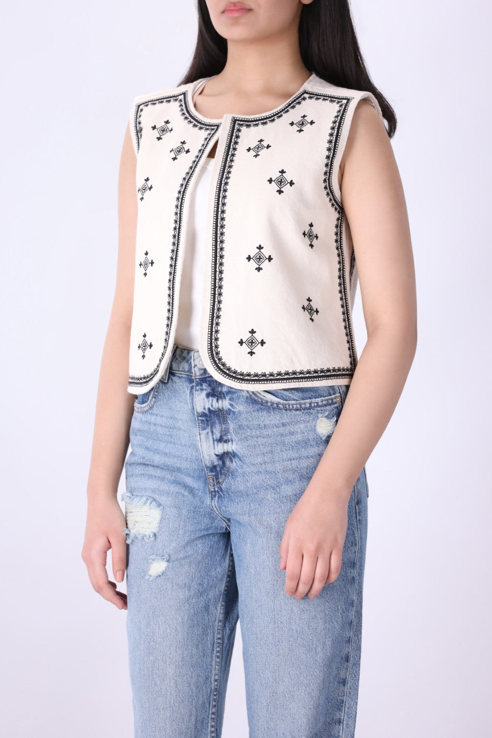 Back view of embroidered ivory vest
