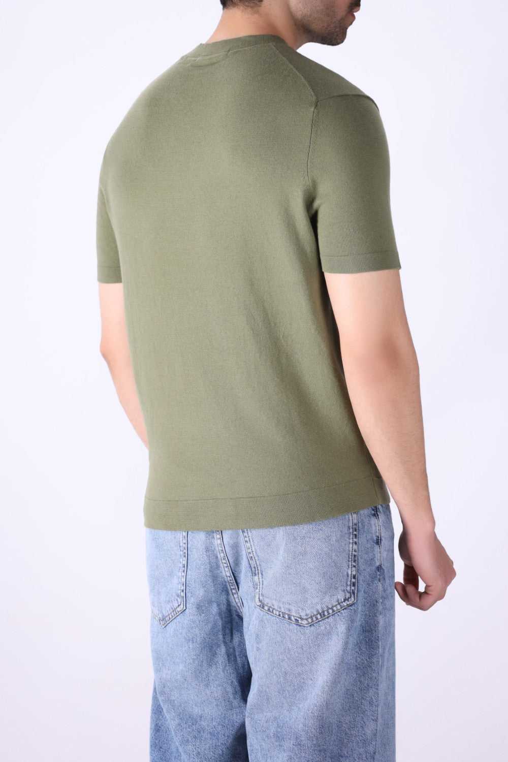 Back view of knitted t-shirt in sage green
