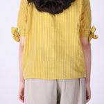Back view of yellow striped shirt
