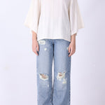 Batwing top in cream styled with slim trousers
