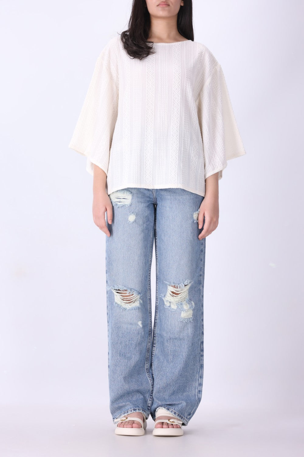 Batwing top in cream styled with slim trousers

