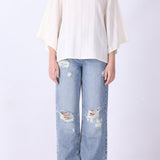 Batwing top in cream styled with slim trousers
