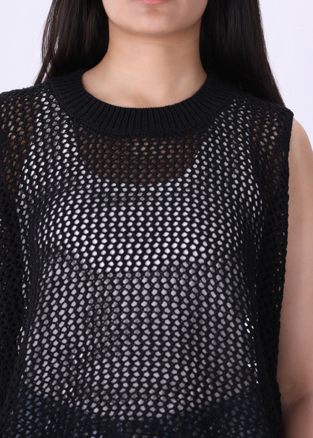 Black crochet top styled with wide-leg trousers
