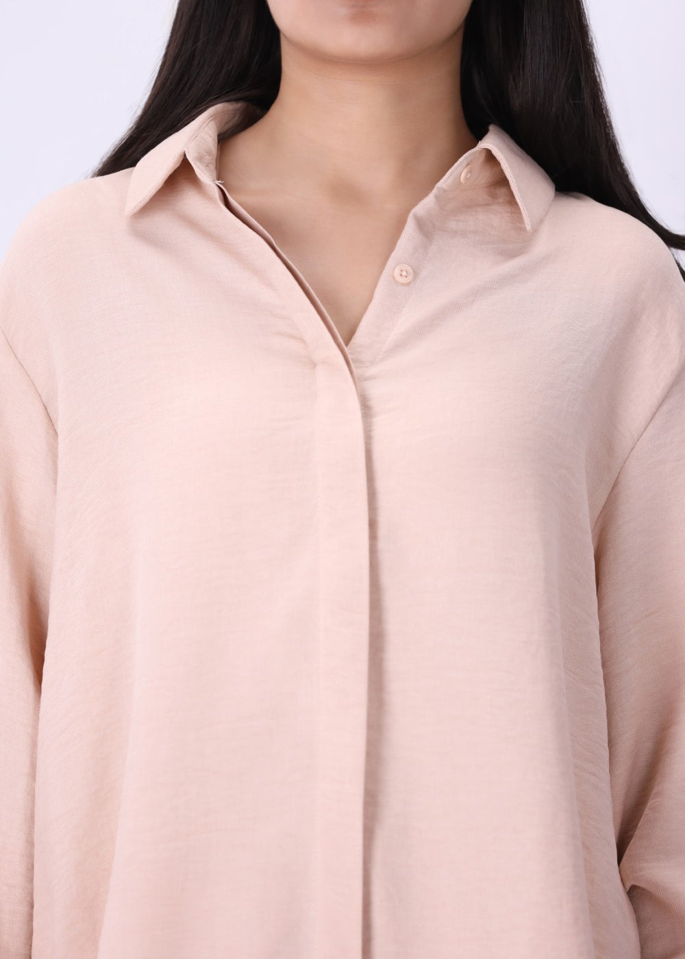 Blush shirt worn open over a tank top

