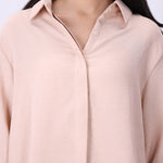 Blush shirt worn open over a tank top
