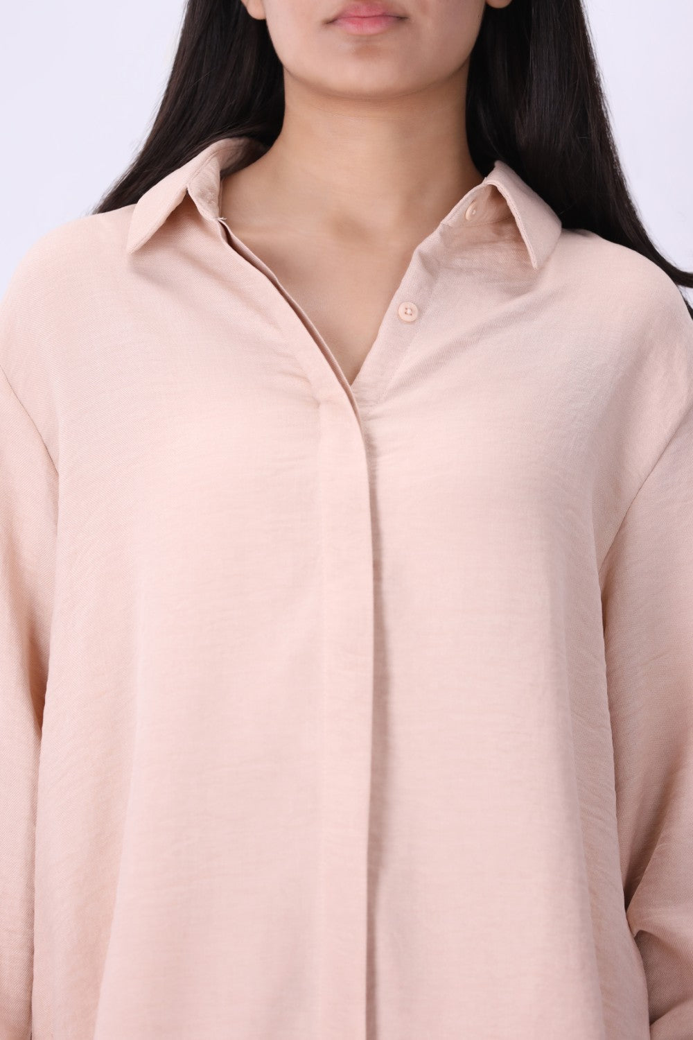 Blush shirt worn open over a tank top
