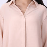 Blush shirt worn open over a tank top
