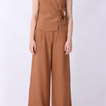 Caramel vest styled with wide-leg trousers