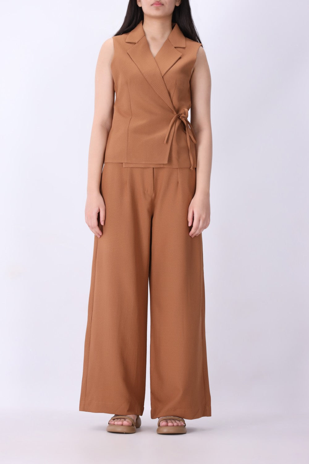 Caramel vest styled with wide-leg trousers