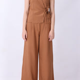 Caramel vest styled with wide-leg trousers