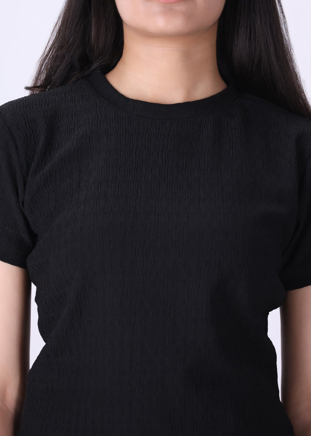 Close-up of ribbed knit texture on black t-shirt
