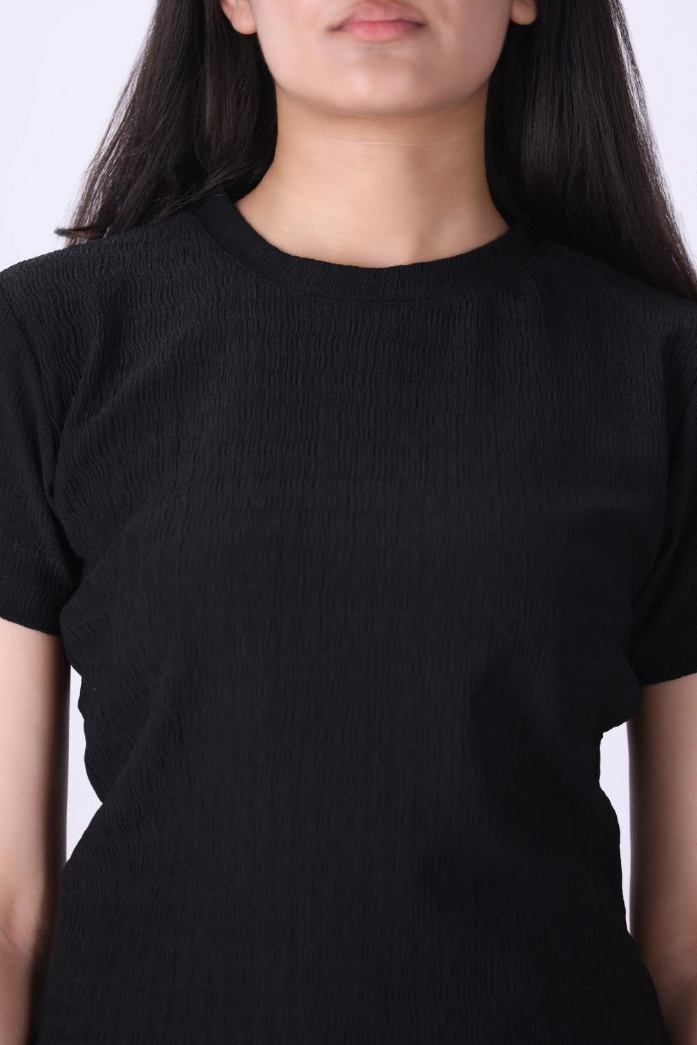Close-up of ribbed knit texture on black t-shirt
