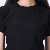 Close-up of ribbed knit texture on black t-shirt
