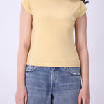 Close-up of ribbed knit texture on latte vest
