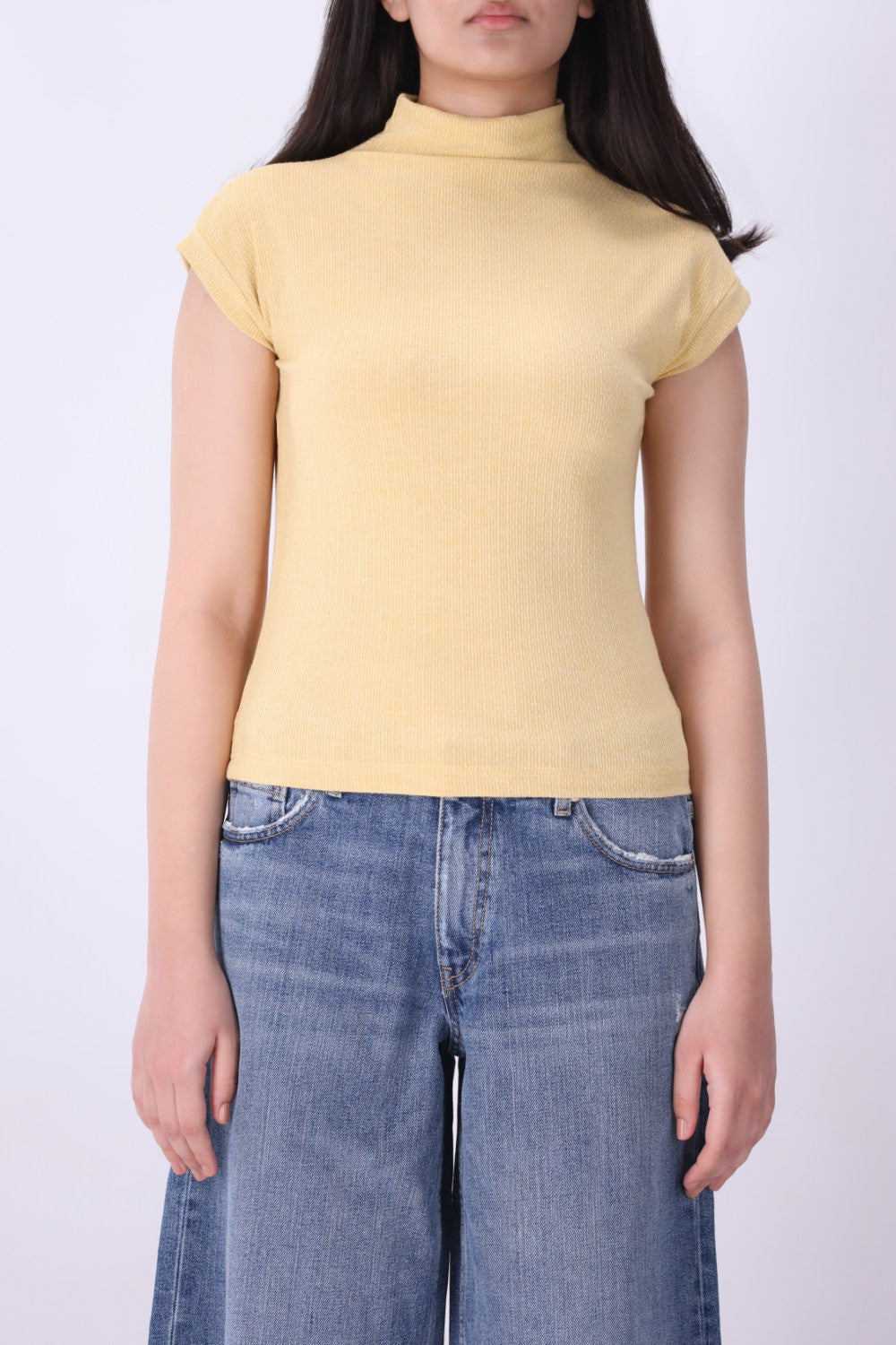 Close-up of ribbed knit texture on latte vest
