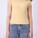 Close-up of ribbed knit texture on latte vest
