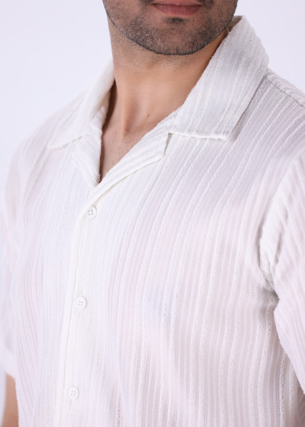 Close-up of vertical grain texture on white fabric
