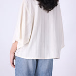 Cream oversized batwing textured top, front view
