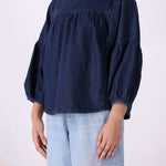 Denim top tucked into tailored trousers
