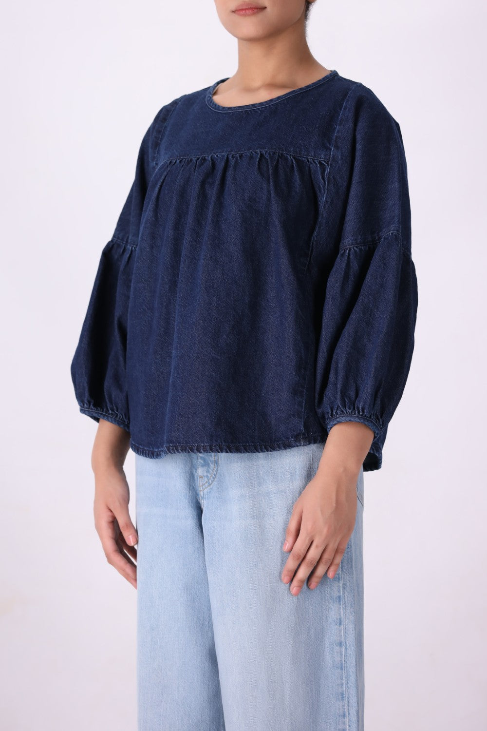 Denim top tucked into tailored trousers