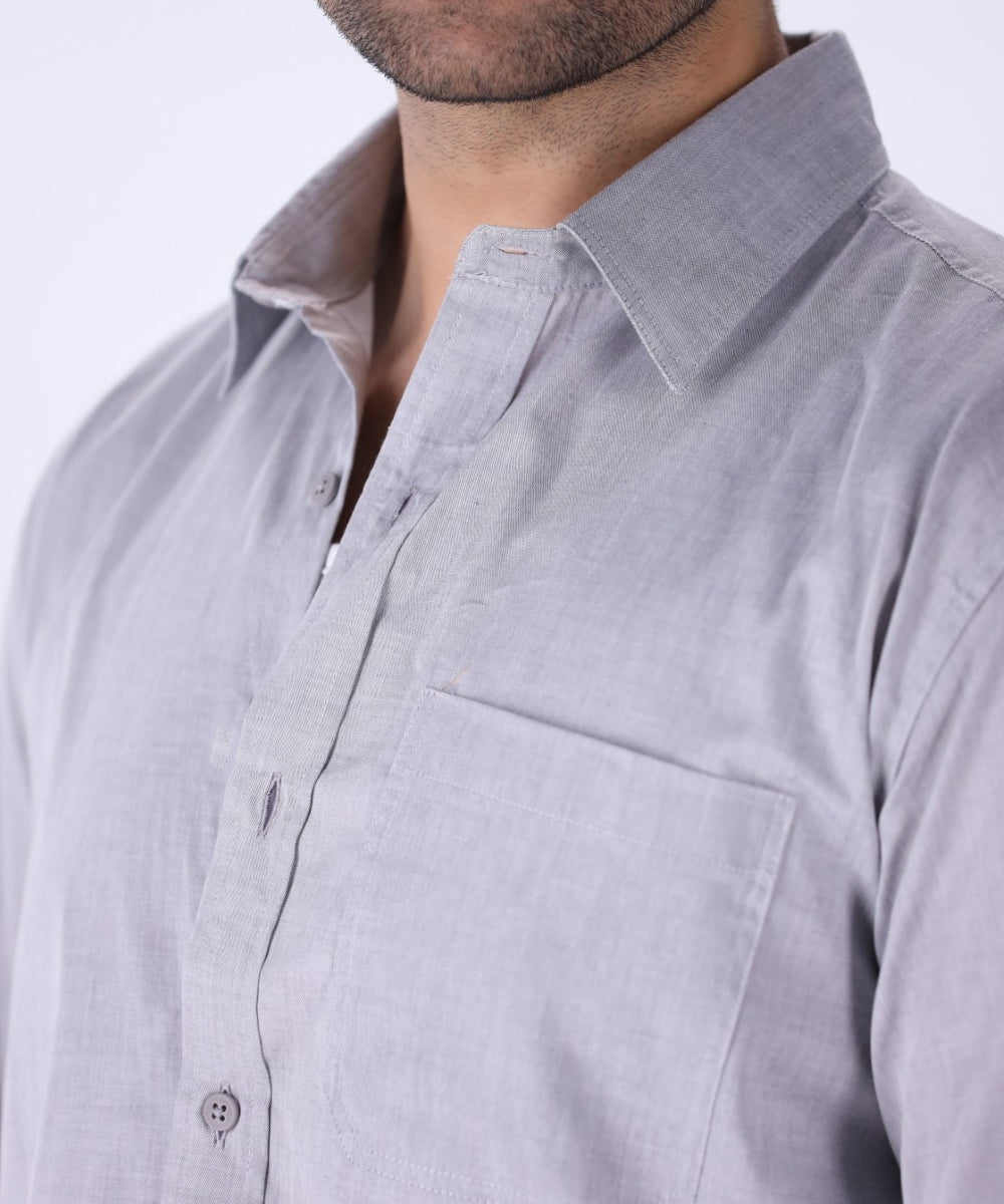 Grey shirt tucked into tailored trousers