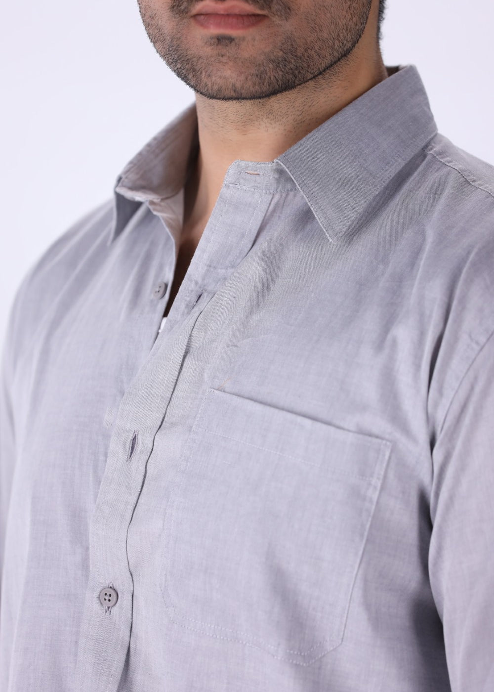 Grey shirt tucked into tailored trousers