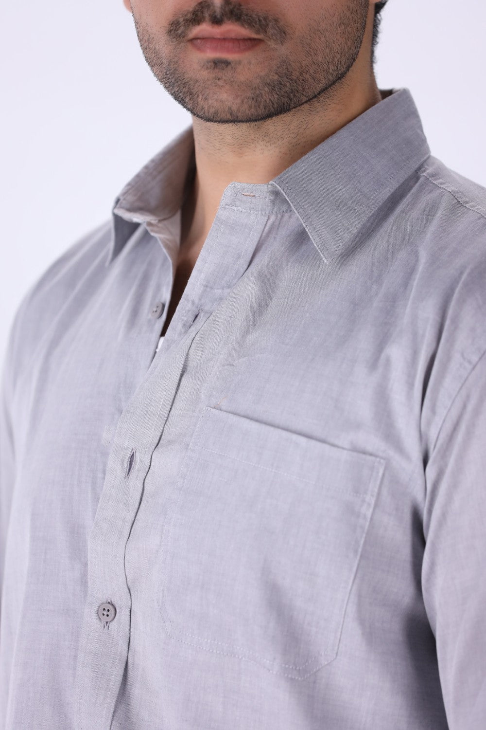 Grey shirt tucked into tailored trousers