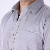 Grey shirt tucked into tailored trousers