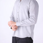 Grey shirt worn open at the collar with denim
