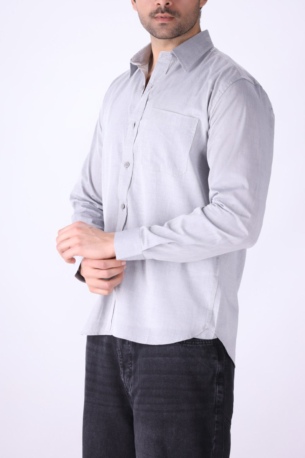 Grey shirt worn open at the collar with denim
