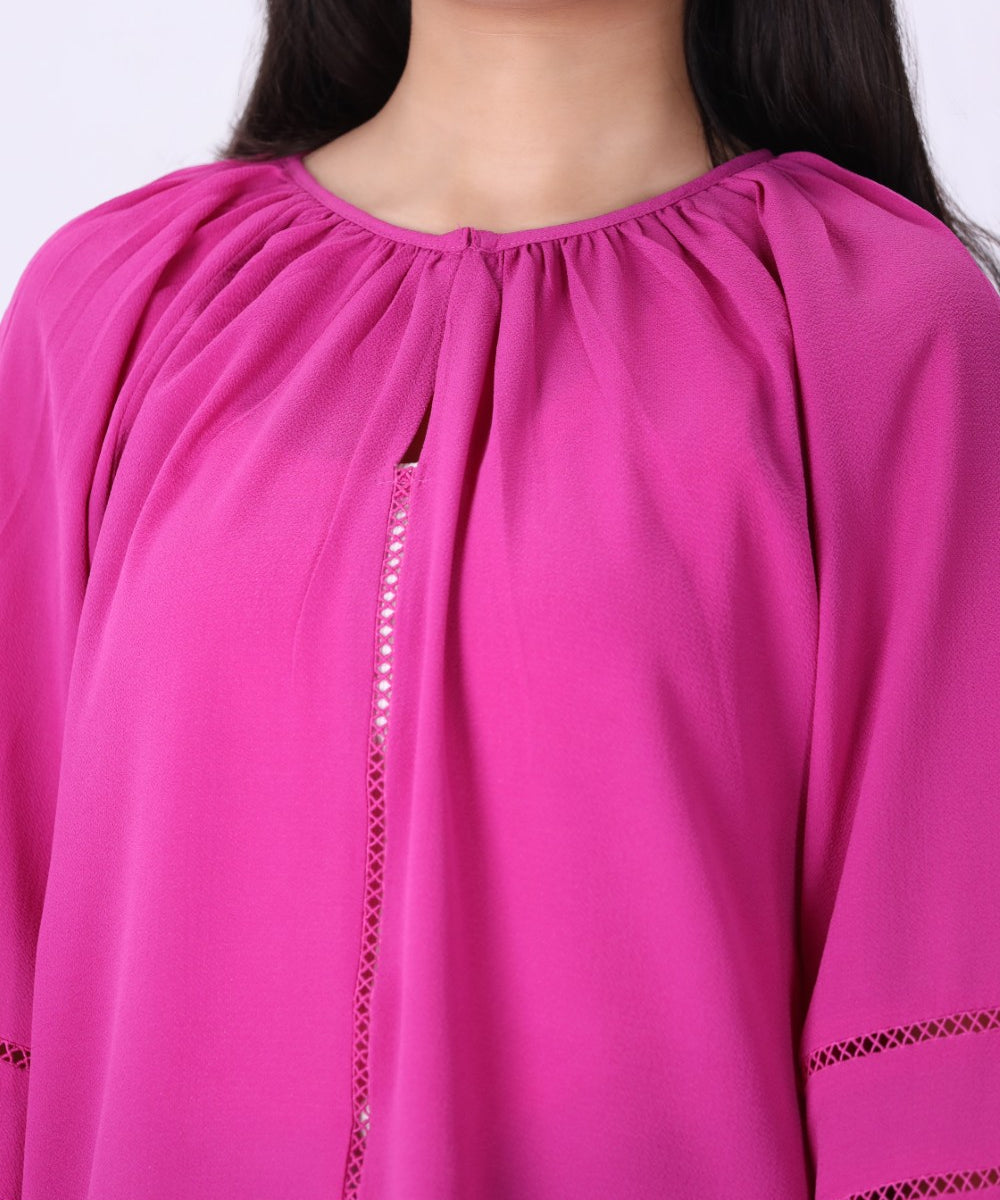 Hot pink blouse styled with white trousers