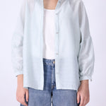 Light blue button-down shirt worn open over a tank
