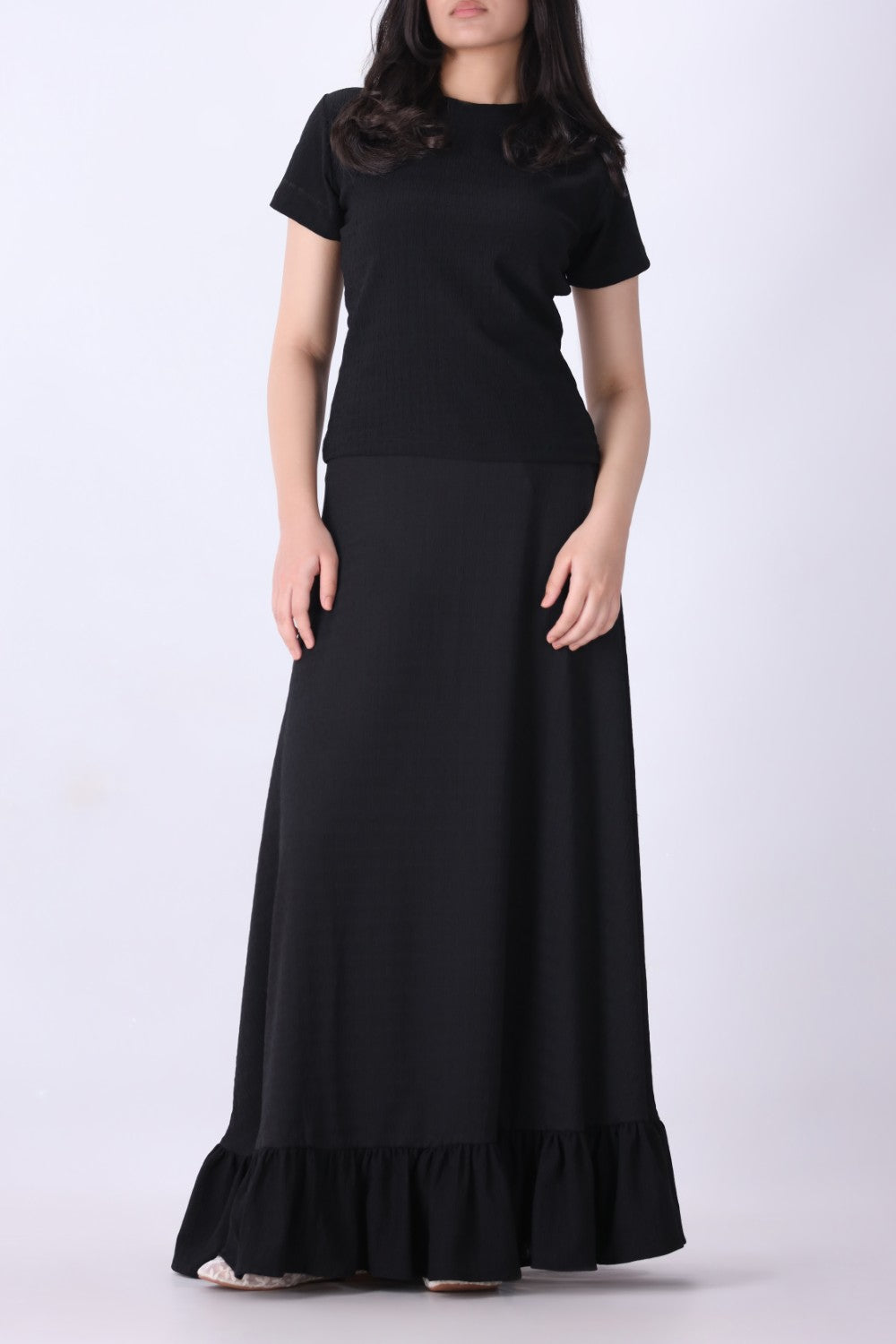 Ribbed black tee tucked into tailored trousers