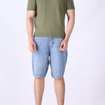 Sage green tee layered under an open shirt
