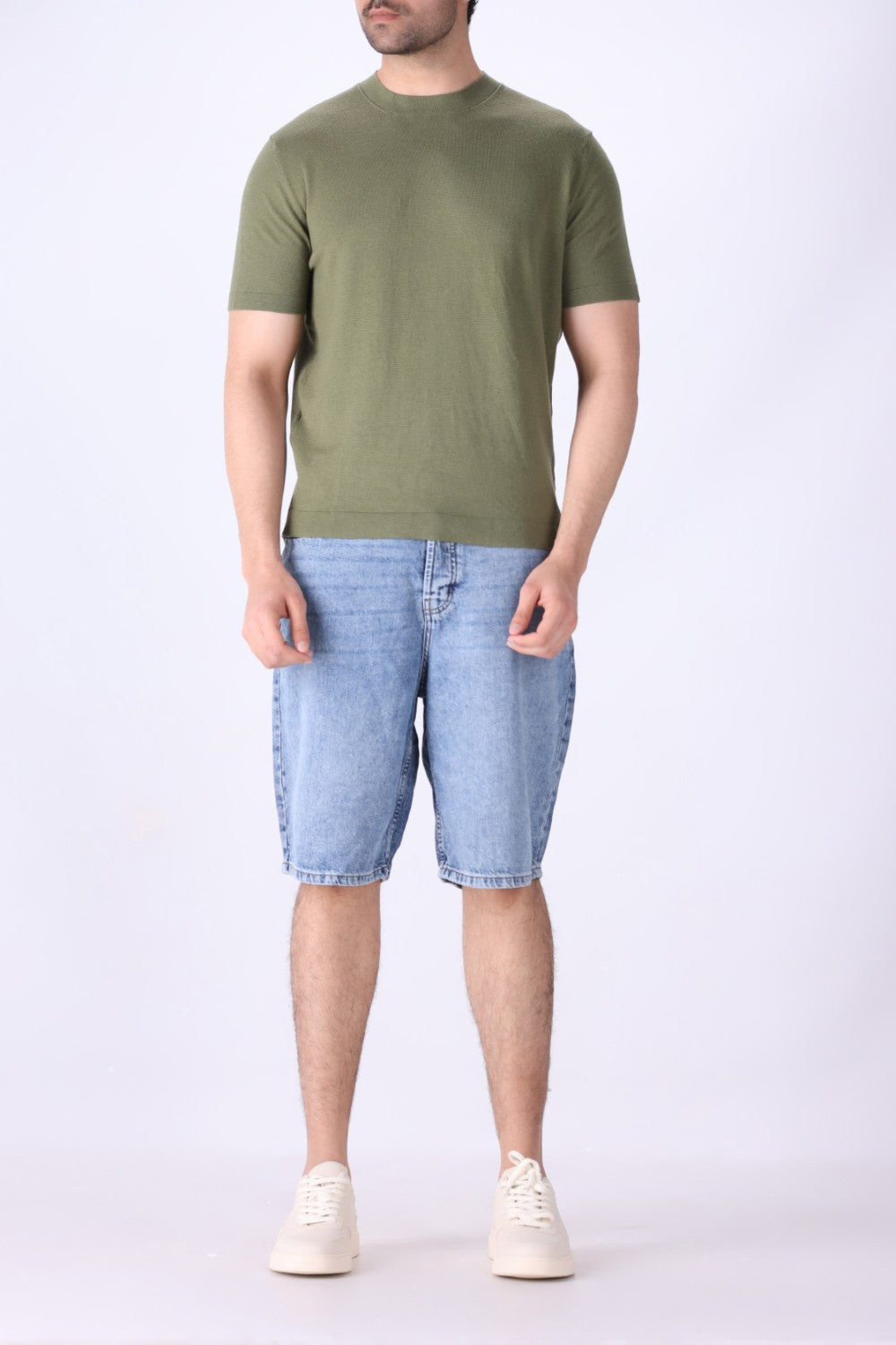Sage green tee layered under an open shirt
