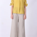 Side view of tie-sleeve button-down shirt
