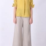 Side view of tie-sleeve button-down shirt
