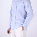 Striped shirt layered under a jacket
