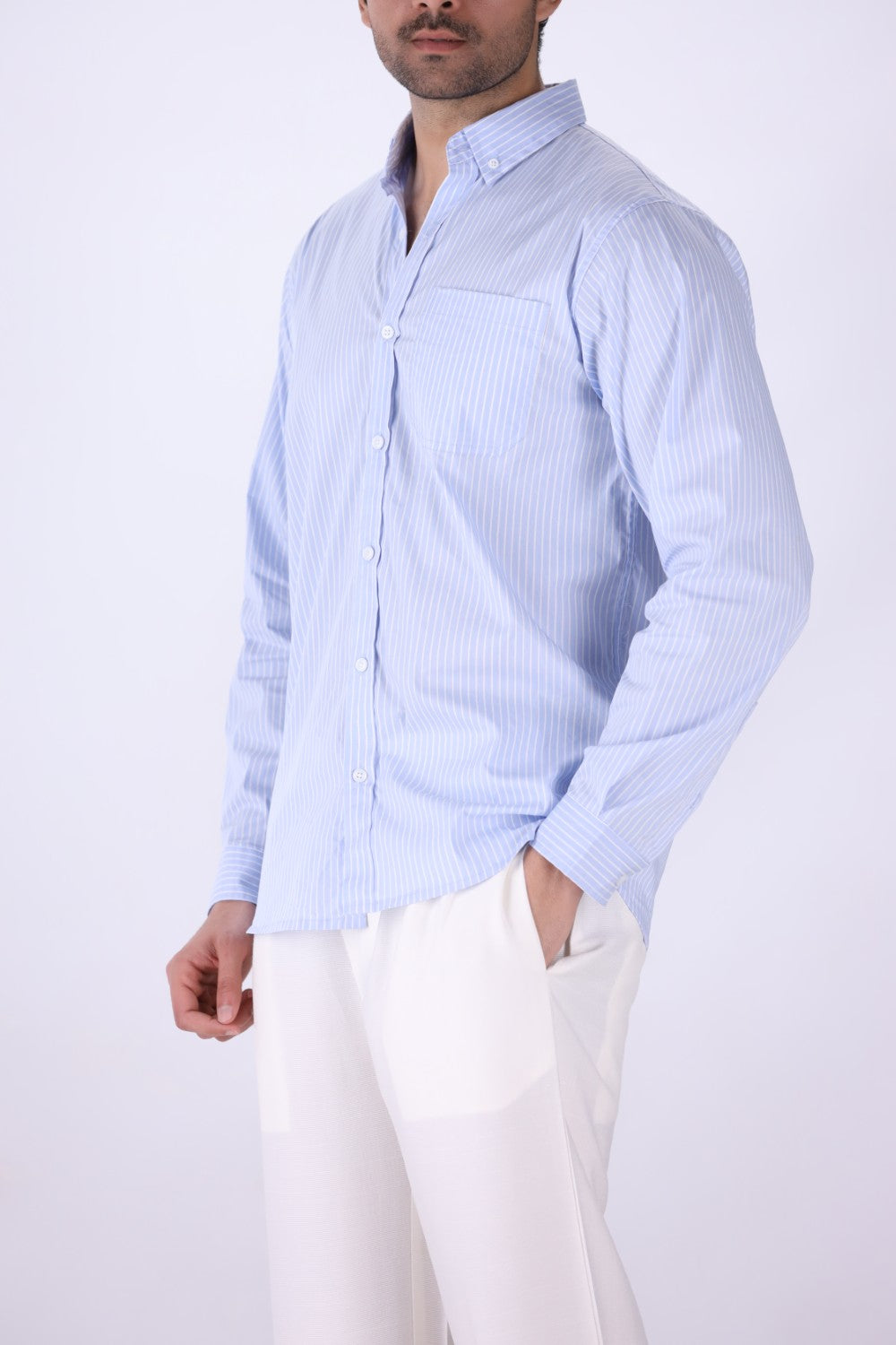 Striped shirt layered under a jacket
