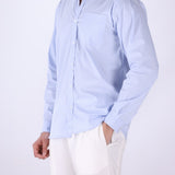 Striped shirt layered under a jacket
