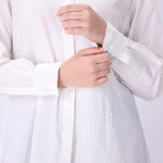 White button-down shirt worn open as a layer