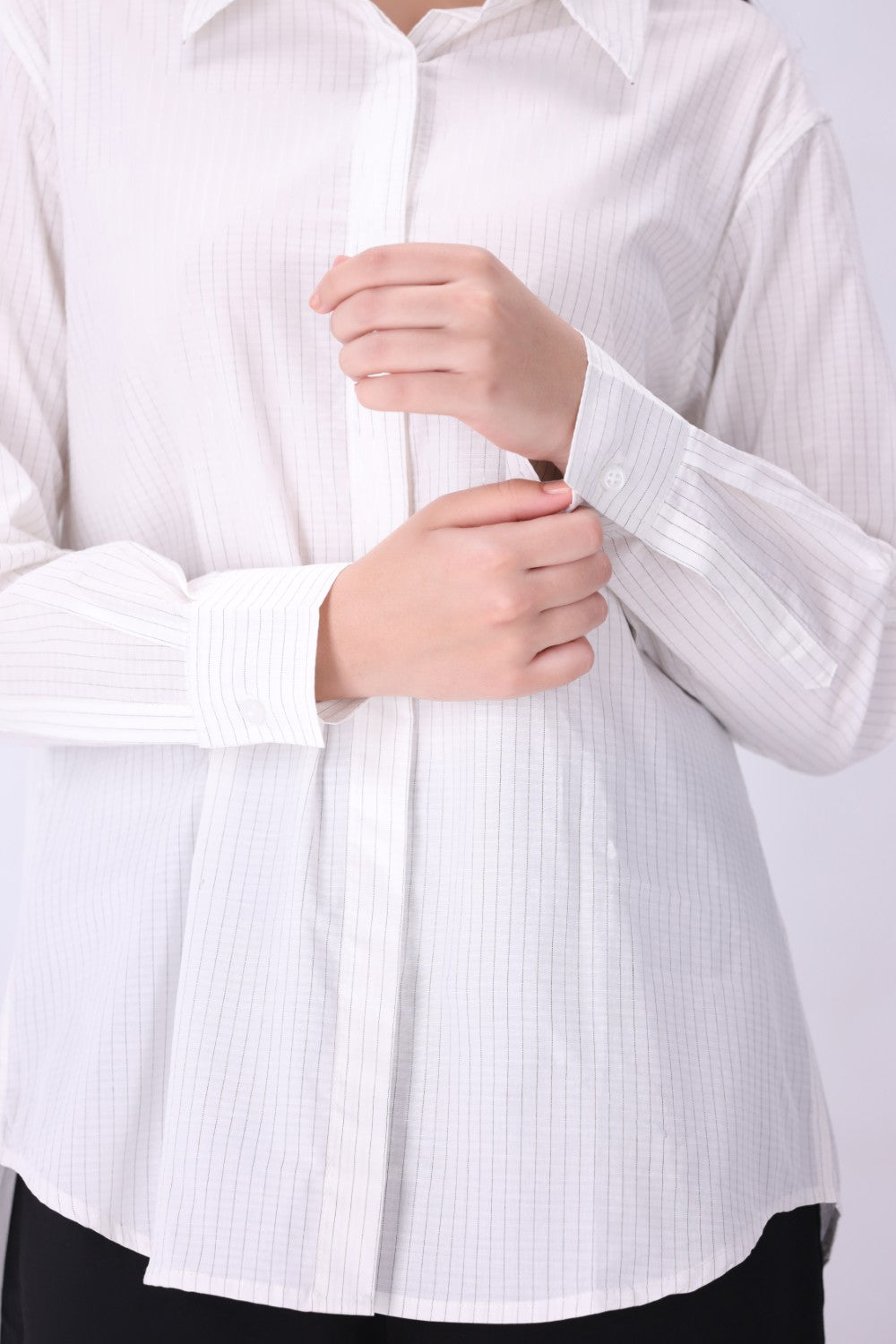 White button-down shirt worn open as a layer