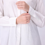 White button-down shirt worn open as a layer