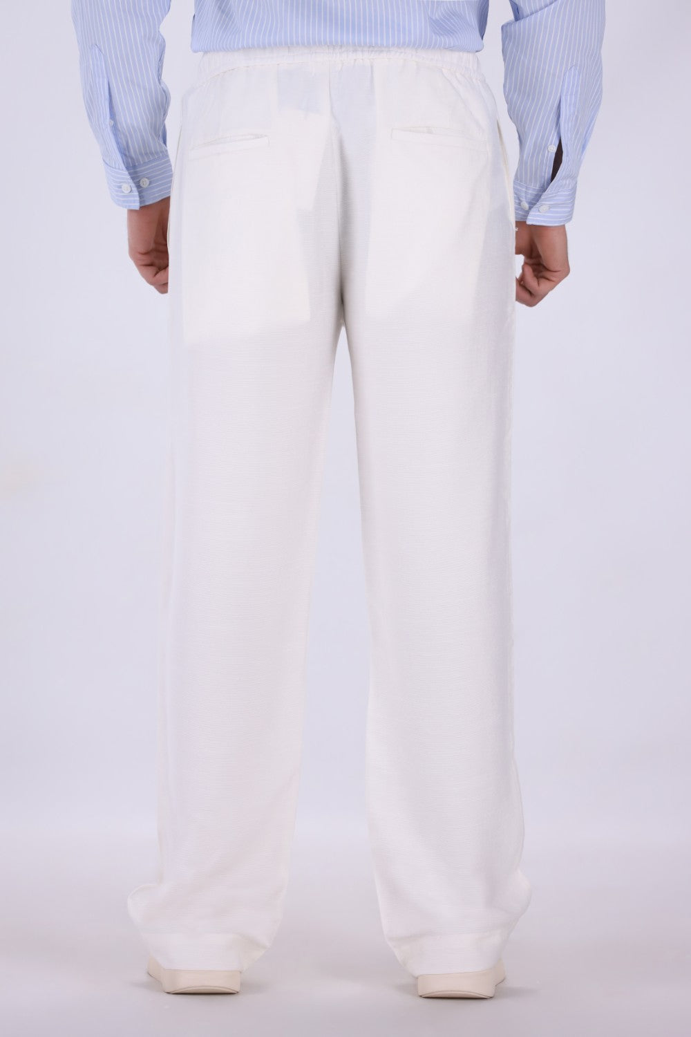 White pull-on trousers worn with loafers
